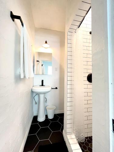 a bathroom with a white sink and a toilet at Heart of Hollywood Apartment - 2Bed 2Bath in Los Angeles