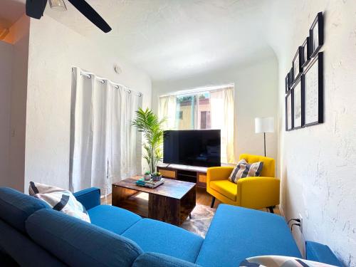 a living room with a blue couch and a yellow chair at Heart of Hollywood Apartment - 2Bed 2Bath in Los Angeles