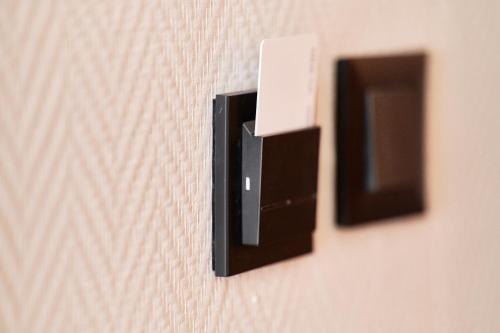 a close up of two switches on a wall at Apartamenty Na Skarpie in Płock
