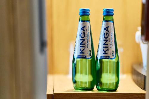 two bottles of soda sitting on a table at Apartamenty Na Skarpie in Płock