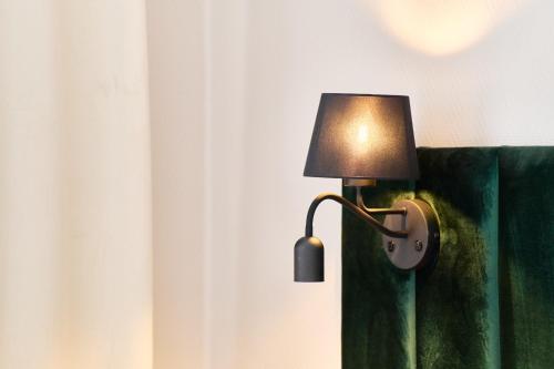 a lamp attached to a wall in a room at Apartamenty Na Skarpie in Płock