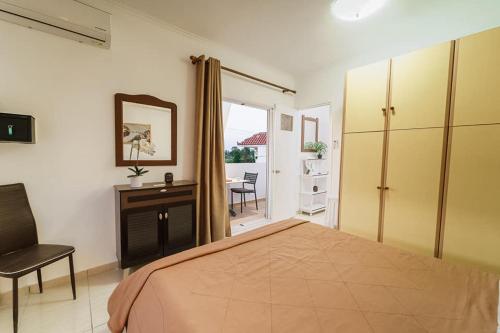 a bedroom with a bed and a desk and a chair at PEDRO NAVARINO ΙΙΙ Laganas in Laganas