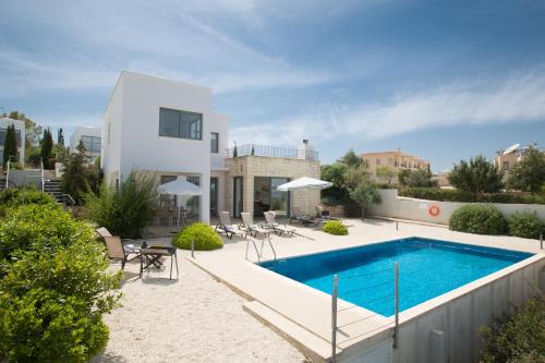 a villa with a swimming pool and a house at Esprit Villa 26 Latchi in Polis Chrysochous