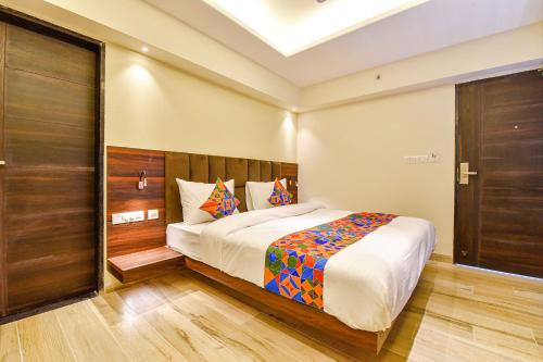a bedroom with a large bed in a room at FabHotel Prime Pink City Park in Jaipur