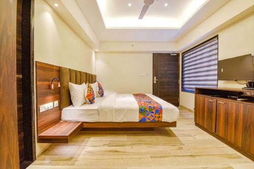 a hotel room with a bed and a television at FabHotel Prime Pink City Park in Jaipur