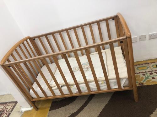 a wooden crib in a corner of a room at 64 Barth in Msida