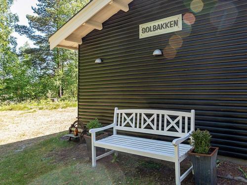 a white bench sitting in front of a house at 5 person holiday home in H jslev in Sundstrup