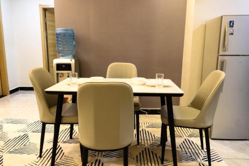 a dining room with a table and chairs at C&C Apartment at Kileleshwa in Nairobi