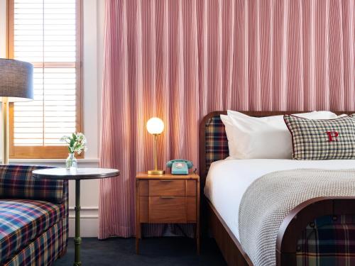 a bedroom with a bed and a table with a lamp at Palihotel San Diego Gaslamp Quarter in San Diego