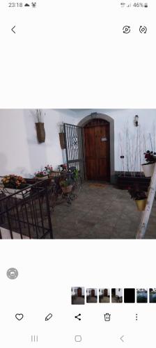 a picture of a house with a door and a table at Luxury b&b Le Rocce in Villasmundo
