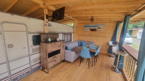 a living room with a couch and a table in a caravan at Каравана Тиана in Sozopol