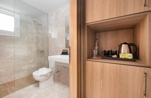 a bathroom with a toilet and a shower and a sink at Smaragdi Kos Hotel in Kos