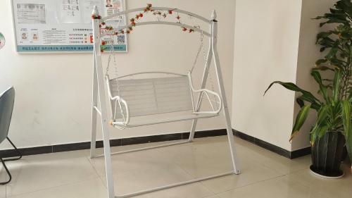 a swing in the corner of a room at Ha Luo Hotel in Kunming