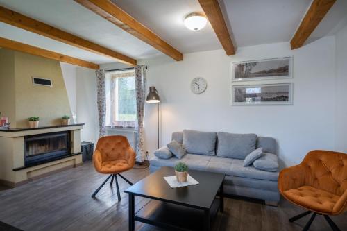 a living room with a couch and two chairs at FARMAOBECKOV sk in Obeckov