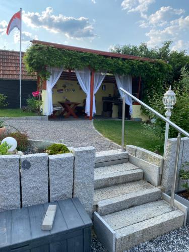 a set of stairs leading to a pavilion with a picnic table at Ferien Wohnung in Bad Säckingen