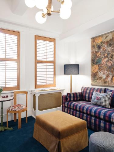 a living room with a couch and a table at Palihotel San Diego Gaslamp Quarter in San Diego