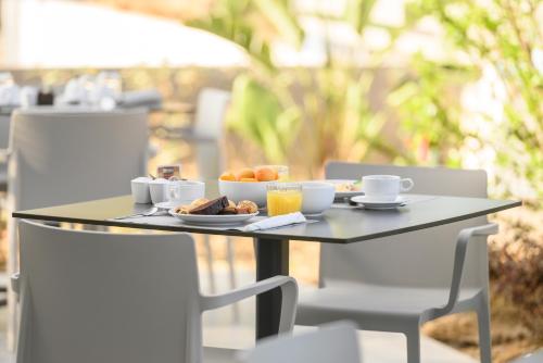 a table with a tray of breakfast food on it at Smaragdi Kos Hotel in Kos Town