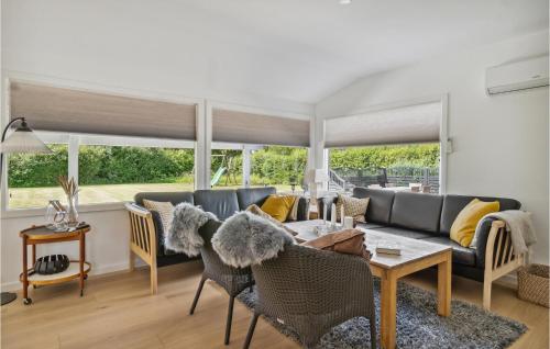 a living room with a couch and a table at Amazing Home In Dannemare With Wifi in Dannemare
