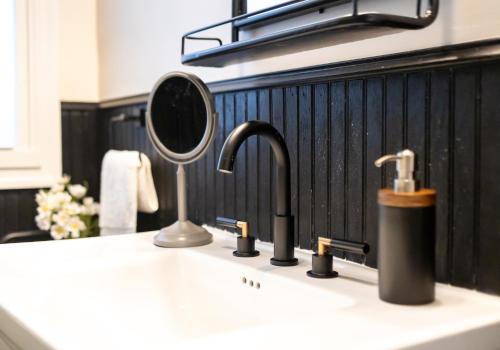 a bathroom counter with a sink with a mirror at Spacious Highland Park Home, Family&pet Friendly in Birmingham