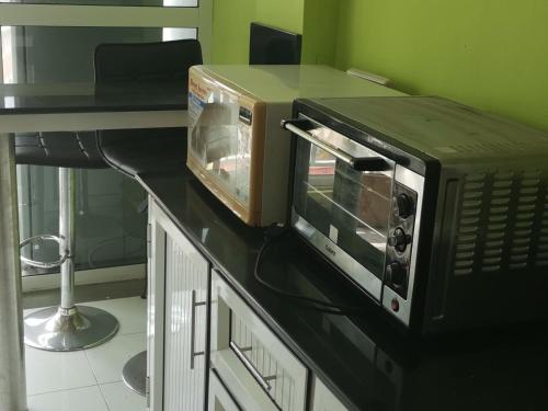 a microwave sitting on top of a counter at complexe les rosiers in Rose Hill