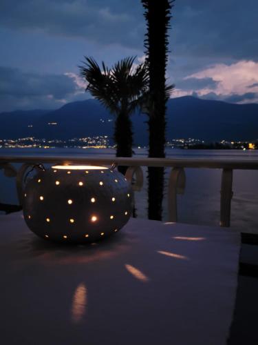 a chair with lights sitting on a table near the beach at Casa Conti al Lago in Ronco s/Ascona - Porto Ronco
