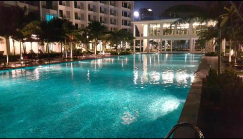 a large pool with blue water in front of a building at Revo Home by AK Group in Cyberjaya