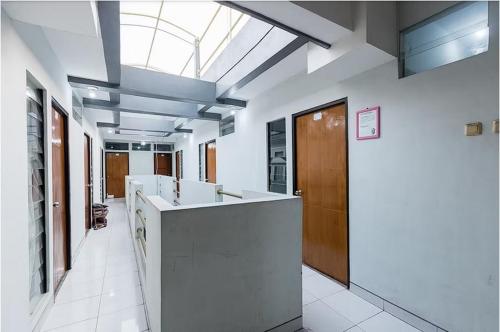a large room with a kitchen with a skylight at Hotel Cemara Gading in Bubulak 3
