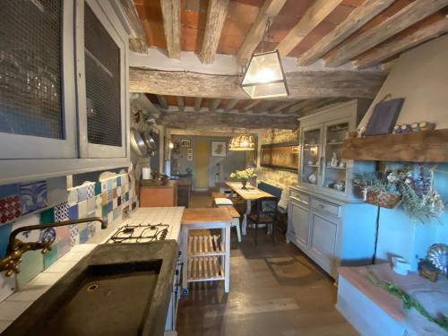 a kitchen with a sink and a table in it at Hotel Villa Sermolli in Borgo a Buggiano