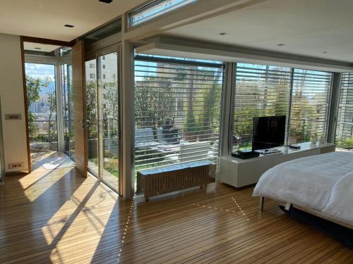 a bedroom with a bed and a large window at Charming Architect Loft withTerrace in Beirut