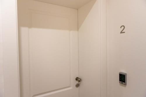 a white door with the number on it at City and Style Luxury Rooms Split in Split
