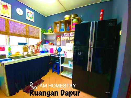 a kitchen with a black refrigerator in a room at Am Homestay Rembau in Rembau