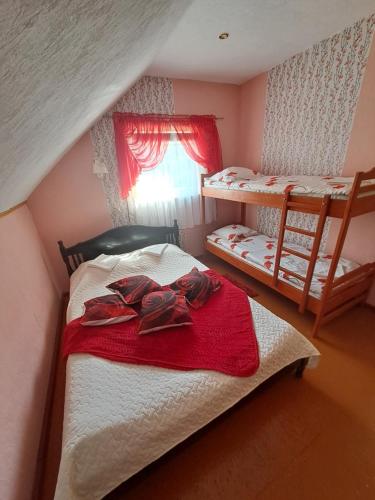 a bedroom with two bunk beds and a window at Imantas in Salacgrīva