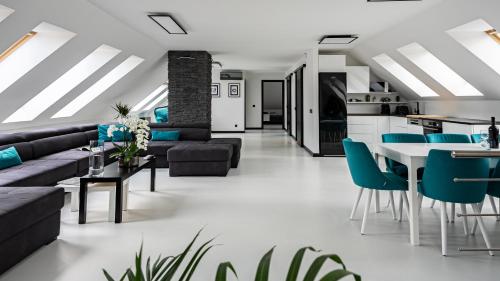 a living room with a couch and a table and chairs at Arácsi Apartman 1610 in Balatonfüred