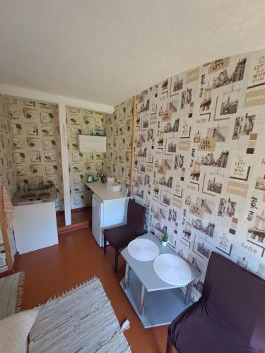 a room with a wall with pictures on it at Imantas in Salacgrīva