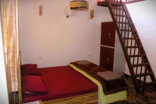 a room with a bunk bed and a staircase at Infinity Hill Village Mukteshwar in Mukteswar