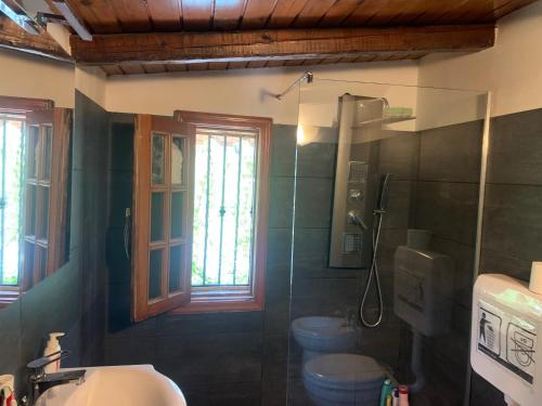 a bathroom with two toilets and a sink and a shower at La Casa Di Iside A Mare in Catania