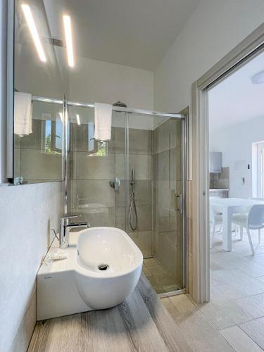 a bathroom with a white sink and a shower at Appartamenti Serena in Peschici