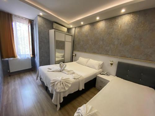 a hotel room with two beds and a mirror at SİSLİ EV 2 in Istanbul