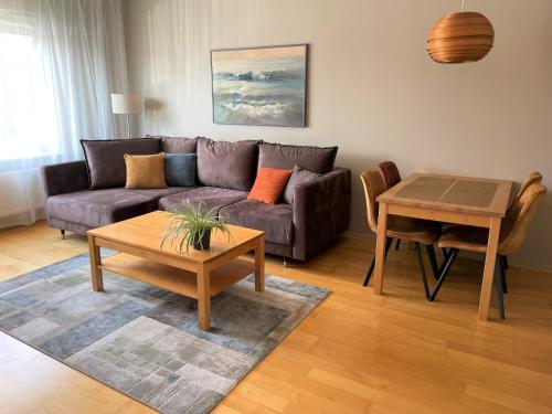 a living room with a couch and a table at Kuressaare Holiday Apartments in Kuressaare