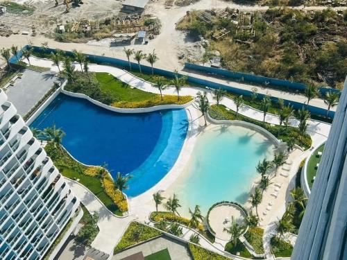 an aerial view of a pool at a resort at LA CASA ALEYKA AZURE NORTH PAMPANGA BALI Tower 518 in San Fernando
