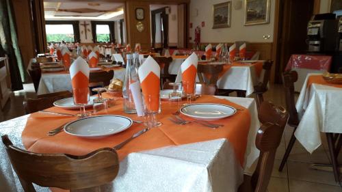 a table with plates and utensils on top at Casa Santa Maria in Folgaria