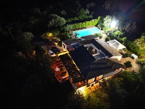 an overhead view of a house with a swimming pool at night at Villa Grimodi in Caronia Marina