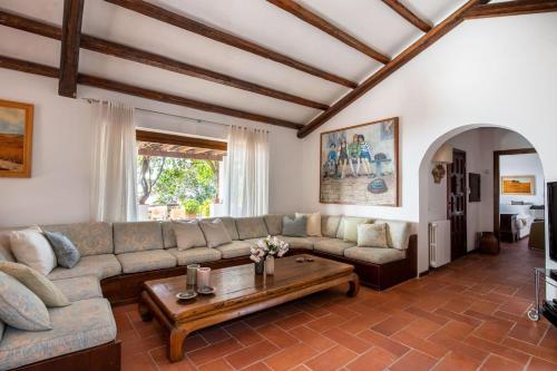 a living room with a couch and a coffee table at Villa Grimodi in Caronia Marina