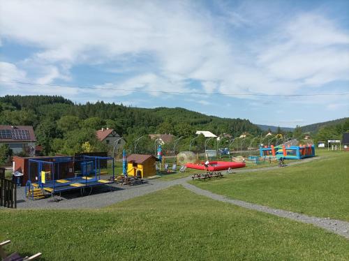 a playground in a park with a green field at chaloupka Karolinka in Karolinka