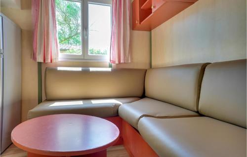 Cette petite chambre comprend un canapé et une table. dans l'établissement 3 Bedroom Nice Home In La Faute-Sur-Mer, à La Faute-sur-Mer