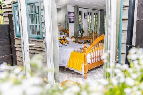 a bedroom with a bed on a porch at Cozy Garden Studio in Williton