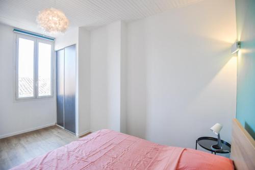 - une chambre avec un lit rose et une fenêtre dans l'établissement ® Le Bernardy - Beau T2 proche de la gare, à Marseille