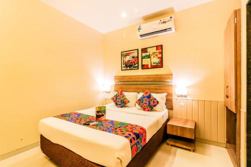 um quarto de hotel com uma cama e duas almofadas em FabExpress Ascot International Andheri East em Mumbai