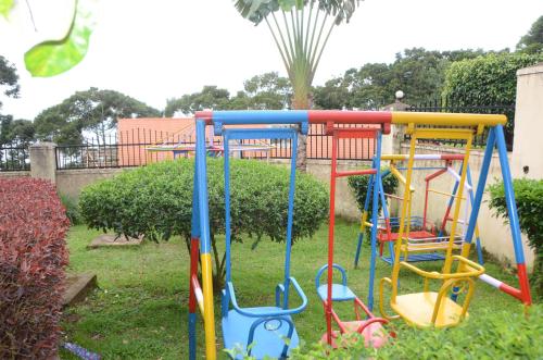a playground with colorful equipment in a yard at WAMALA RESORT HOTEL SSESE in Kalangala