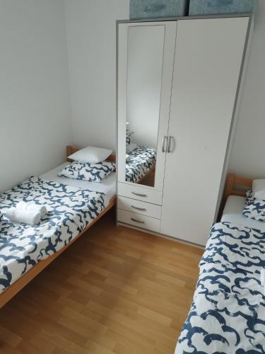 a bedroom with two beds and a mirror at Summer cottage with breathtaking view in Zečevo Rogozničko
